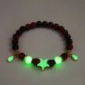 Detailed view of luminous beaded bracelet with green glowing star and red tiger eye beads. - #14 Golden Red Tiger's Eye Bracelet