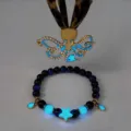 Macro view of luminous octopus pendant and star charm beaded bracelet set for beach - Gold Blue Glow Necklace Bracelet Set
