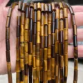 Macro detail of 4x13mm natural yellow tiger eye cylindrical beads for jewelry making. - Tube (JDXYZ03) / 29 Pieces/Pack / Natural Yellow Tiger Eye
