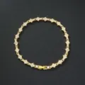 Detailed view of gold floral cross tennis bracelet with sparkling stones and clasp - Gold Base (White Rhinestone)
