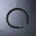 Close-up view of a black flower tennis bracelet with sparkling stones on dark background. - 7inch(18cm) / Black Base (Black Rhinestone)