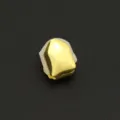 Detailed macro view of a single smooth gold-plated hip-hop tooth grill with silicone mold - Smooth Gold