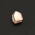 Detail of a rose gold single tooth grillz with glossy finish for hip hop street style - Smooth Rose Gold