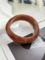 Dettaglio della trama marmorizzata di un bracciale geometrico vintage in acrilico ambra. - Marrone (1519)