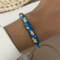 Detailed macro view of the gold leaf pattern on the blue drip oil bangle bracelet - Dark Blue (887-4)