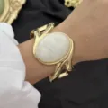 Vintage goldfarbenes breites Manschettenarmband mit großem ovalem weißem Kunstmarmorstein - Wirbel Weiß Geometrisch