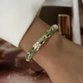 Elegant macaron enamel flower gold bangle bracelet with sparkling crystals on wrist - Golden Macaron Green Texture (883-2)