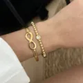 Elegantes goldenes Armreif-Set mit Unendlichkeitssymbol und Perlen für Damen. - Infinity Symbol and Bead Rhinestone Jewelry (764-2) / Gold