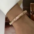 Elegant macaron pink enamel bangle with gold floral accents for a fresh summer look - Pink Enamel Gold Relief Floral (883-8)