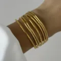 Bracciale rigido multistrato in acciaio inossidabile dorato con motivo a onde strutturato - Linee Irregolari