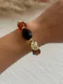 Elegantes Vintage-Armband aus Acrylperlen in Bernstein mit goldenen geometrischen Teilen - Transparentes Kaffee & Braun & Gold