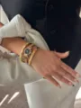 Detail of a gold hexagonal watch with black dial and matching diamond bracelets - Watch And Bracelet Set / Gold/Black Dial