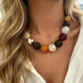Close-up of multi-color large bead necklace on a model for Bohemian style - Amber Marble Large Round Bead Style (A841-3) / Amber Gold Patchwork (A841-3)