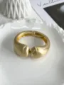 Detailed macro view of matte gold wave bangle with brushed metal texture. - Geometric Wave Style (Matte Gold 213) / Matte Gold 213