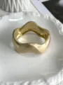 Close-up view of the matte brushed finish on this gold geometric wavy metal bangle - Irregular Curved Style (Matte Gold 208) / Matte Gold 208
