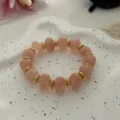 Elegante bracciale con perle rosa pesca e distanziatori dorati su vassoio bianco - Stile con Perline Irregolari (823) / 13 Pezzi (10mm) / Rosa