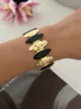 Bracciale rigido aperto in smalto dorato esagerato con accenti ovali neri da donna - Ovale / Nero/Oro