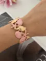 Massives rosa Emaille-Armband im Ozean-Design mit goldenen Seesternen und Muscheln - Schneckenhaus Seestern Stil / Rosa Gold
