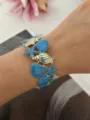 Ozean-Thema Emaille-Armreif mit Seestern- und Muscheldetails in Blau- und Gold-Finish. - Schneckenhaus Seestern Stil / Blau/Gold