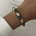 Detailed macro shot of vintage blue and white floral enamel bangle with gold metal trim - 6CM Diameter / Blue White Gold Cloud Pattern (BR26Y0272-3)