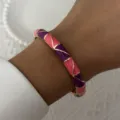 Detailed macro shot of a vintage pink and purple enamel bangle with elegant gold trim detail - 6CM Diameter / Pink and Purple Geometric Style (BR26Y0272-6)