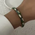 Detailed close-up of a vintage green enamel bangle featuring a white eye pattern design. - 6CM Diameter / Dark Green Evil Eye (BR26Y0272-5)