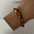 Detail of a vintage red enamel bangle with intricate gold floral patterns on a wrist - 6CM Diameter / Red Floral (2#BR26Y0270-2)