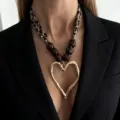 Close-up of a leopard print silk scarf necklace featuring a large golden molten heart pendant. - Leopard Scarf Wood Beads Large Heart Style / Mixed Color (7536)