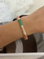 Colorful enamel bamboo joint bangle bracelet with gold accents on a female wrist - Brown Green Multi