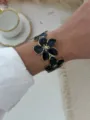 Eleganter offener Armreif mit schwarzen Emaille-Blumen und Vergoldung am Handgelenk - Schwarze Glasur Blume Offener Armreif
