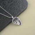 Detailed view of men's stainless steel guitar pick necklace with rock music notes pendant. - Corn Chain Style