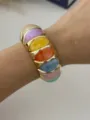 Chic multicolor marbled resin elastic bracelet with gold-tone metal frame on wrist - Rainbow Color Block Style