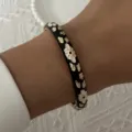 Elegant vintage black enamel bangle bracelet with intricate gold floral patterns on wrist - 6CM Diameter / Black Base Gold and White Floral Style (BR26Y0273-4)