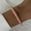 Vintage-style pink enamel bangle bracelet with intricate gold floral patterns on wrist - 6CM Diameter / Pink Gold Floral (BR26Y0277-2)