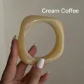 Detailed view of an irregular milk coffee acrylic bangle featuring a marbled translucent texture - Milk Coffee