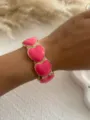 Detailed view of a vibrant rose pink enamel heart-shaped bangle bracelet on a wrist - Heart Puzzle Style / Fuchsia Heart 1583