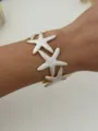 Brazalete de estrella de mar único en acero inoxidable dorado con esmalte blanco en la muñeca - Oro Blanco Estrella de Mar