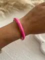 Rose pink enamel bangle bracelet with gold plating trim shown on a model's wrist - Fuchsia Thin Round 3583