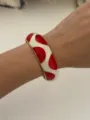 Bohemian red and white enamel dripping oil bangle bracelet for women on model wrist - Red and White Gold (3557)