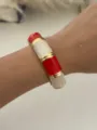 Bohemian gold alloy bangle with red and marbled white enamel sections on wrist. - Red and White Gold (157)