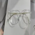 Stylish lightweight round clear glasses frame for women featuring gold metal temples - Clear / Photochromic Lenses