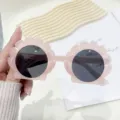 Adorable shell-shaped pink children's sunglasses providing outdoor UV protection - Jelly Pink Frame Grey Lens