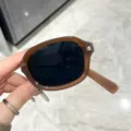 Occhiali da sole vintage pieghevoli con una montura marrone ambra traslucida elegante - Montatura Tè Pieghevole Lenti Grigie