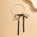 Elegant vintage white pearl necklace featuring a long black ribbon bow tie for women - Single Layer Style (875619) / Black