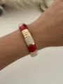 Elegant bohemian enamel alloy bangle featuring red and marble white segments on a wrist - Red and White Gold (2553)