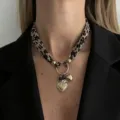 Detailed macro shot of a leopard print silk scarf necklace with golden heart pendants. - Gold (7535)