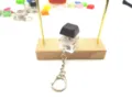 Close-up of a stress relief mechanical keycap keychain with a black cap and clear base - Black