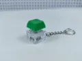 Detail view of a glowing mechanical keyboard switch keychain with green keycap and clear case. - With Lights / 003