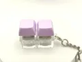 Close-up detail of purple dual keycap mechanical switch keychain with clear base and metal ring. - Solid Color with Light (2 Keys) - Light Purple