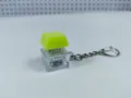 Mechanical keyboard switch fidget keychain toy with bright green keycap and clear base detail. - 008